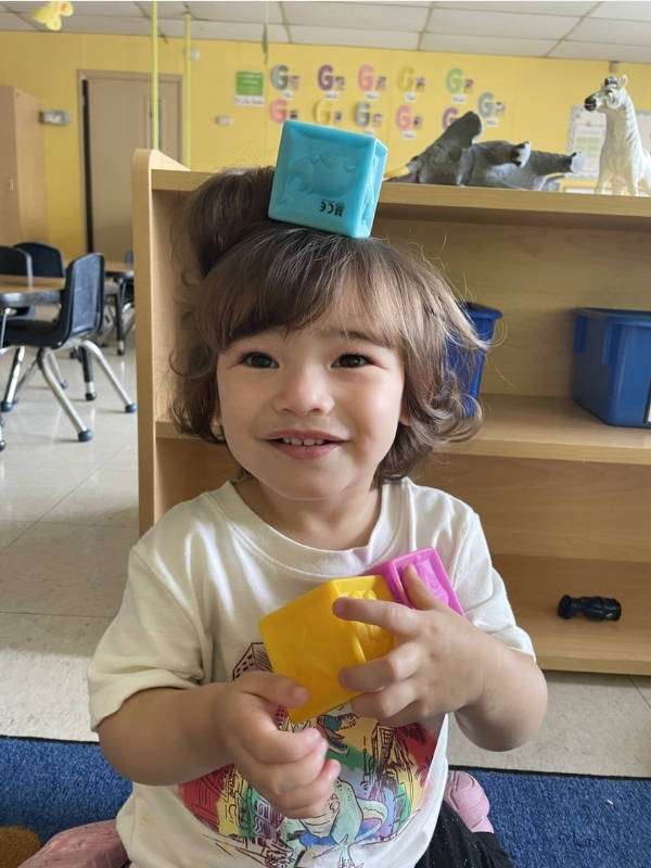 Megan, a little girl, playing with blocks